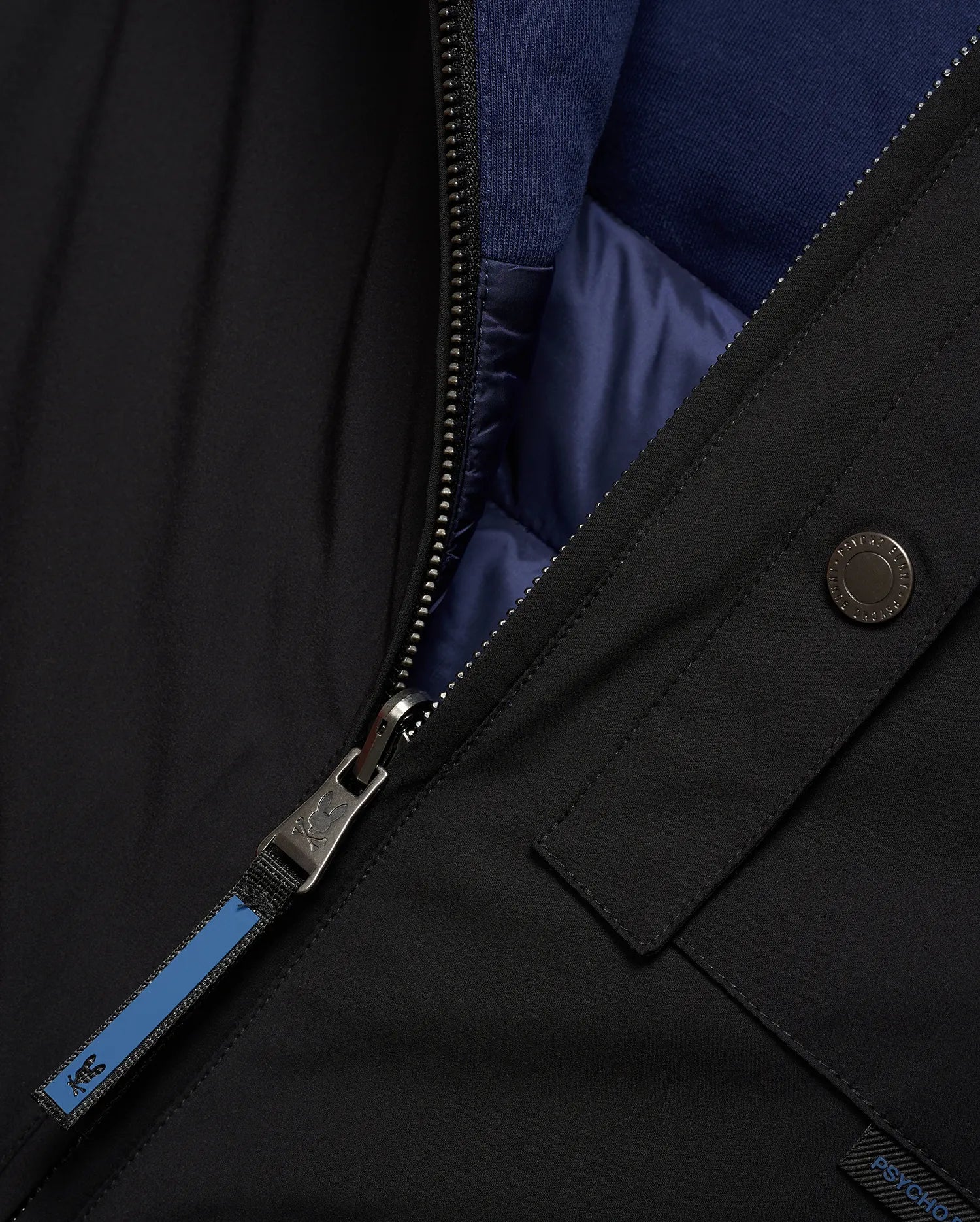 Mens Gordler Reversible Vest, black smooth woven outer, reversible to navy blue quilted interior with ribbed collar. Features a full zip with Psycho Bunny skull logo pull, branded snap, and Psycho Bunny text tag.