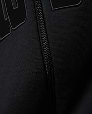 Mens Joaquin Mix Media Reversible Bomber in black, showcasing large raised black letters with a subtle grey outline on a smooth knit fabric, alongside a black front zipper.