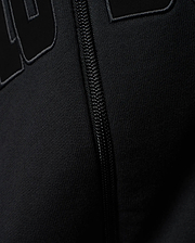 Mens Joaquin Mix Media Reversible Bomber in black, showcasing large raised black letters with a subtle grey outline on a smooth knit fabric, alongside a black front zipper.
