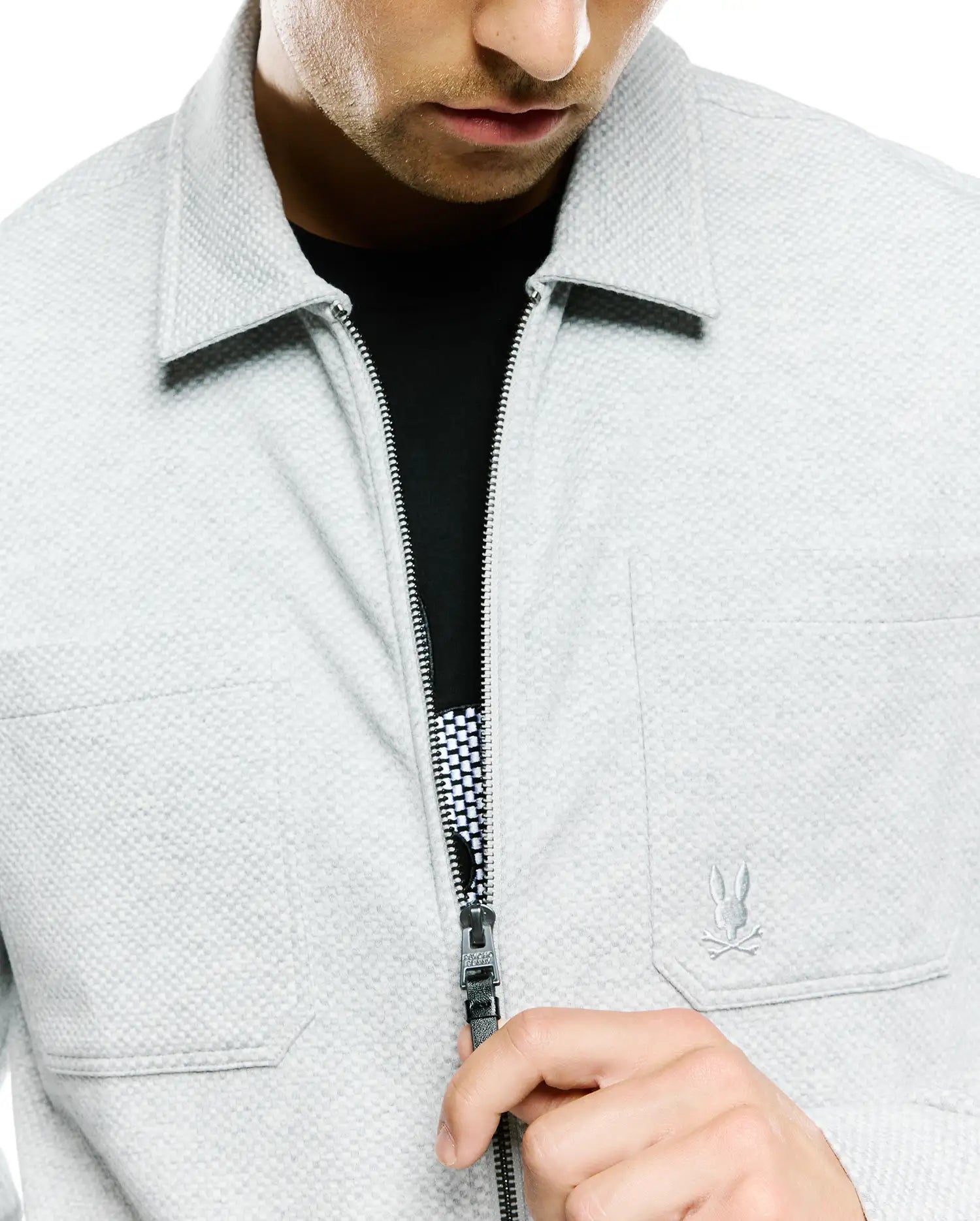 Light grey Mens Marc Textured Overshirt, classic fit, featuring a full-zip closure with branded pull, small embroidered Psycho Bunny skull logo on the right chest, and a black/white checkered zipper lining.