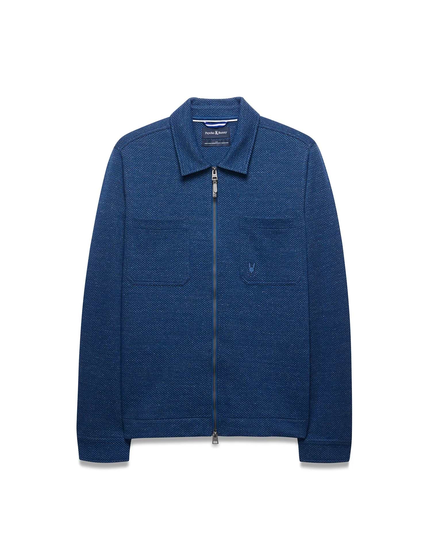 Mens Marc Textured Overshirt in deep indigo blue, featuring a full-zip front, classic collar, two chest patch pockets, and a small embroidered Psycho Bunny skull logo on the left chest.