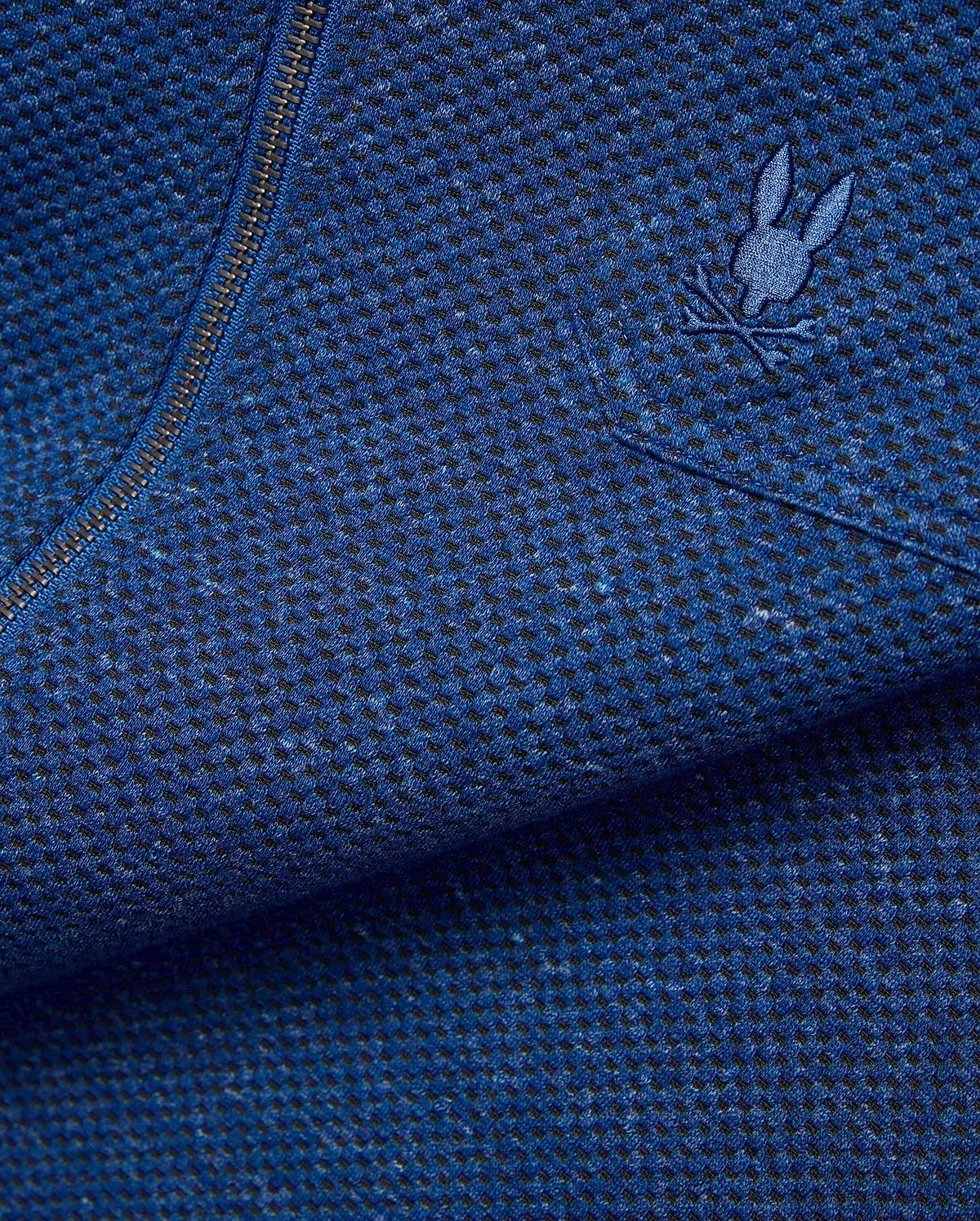 Mens Marc Textured Overshirt in deep blue heathered knit fabric with black flecks, featuring a dark metallic zipper and a small embroidered blue Psycho Bunny skull logo on the chest.