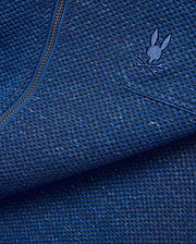 Mens Marc Textured Overshirt in deep blue heathered knit fabric with black flecks, featuring a dark metallic zipper and a small embroidered blue Psycho Bunny skull logo on the chest.