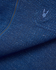 Mens Marc Textured Overshirt in deep blue heathered knit fabric with black flecks, featuring a dark metallic zipper and a small embroidered blue Psycho Bunny skull logo on the chest.