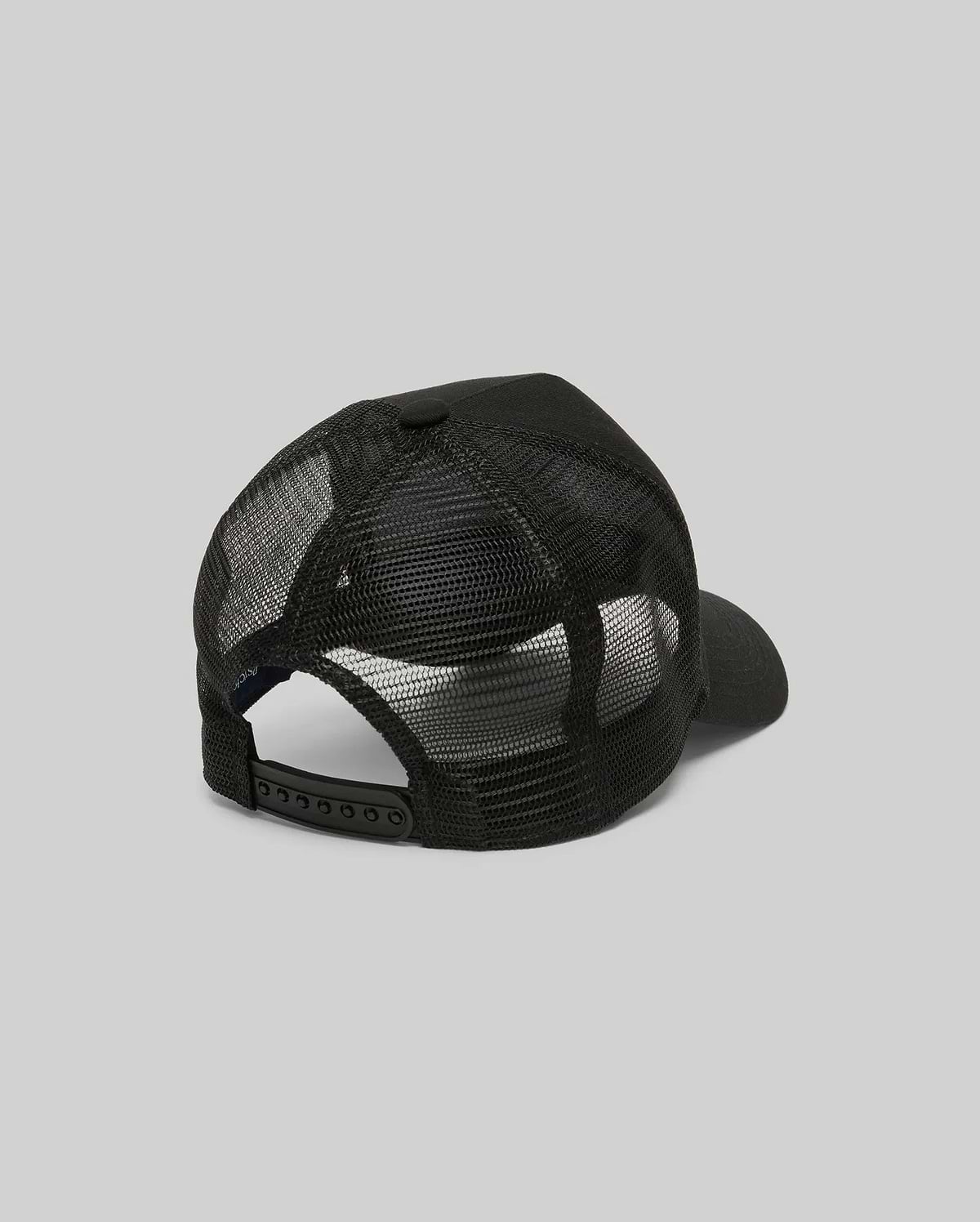 The Psycho Bunny MENS RYDER TRUCKER CAP (MO1500030) in black mesh and cotton twill is shown from the back, featuring an adjustable snapback closure and curved brim against a plain gray background.