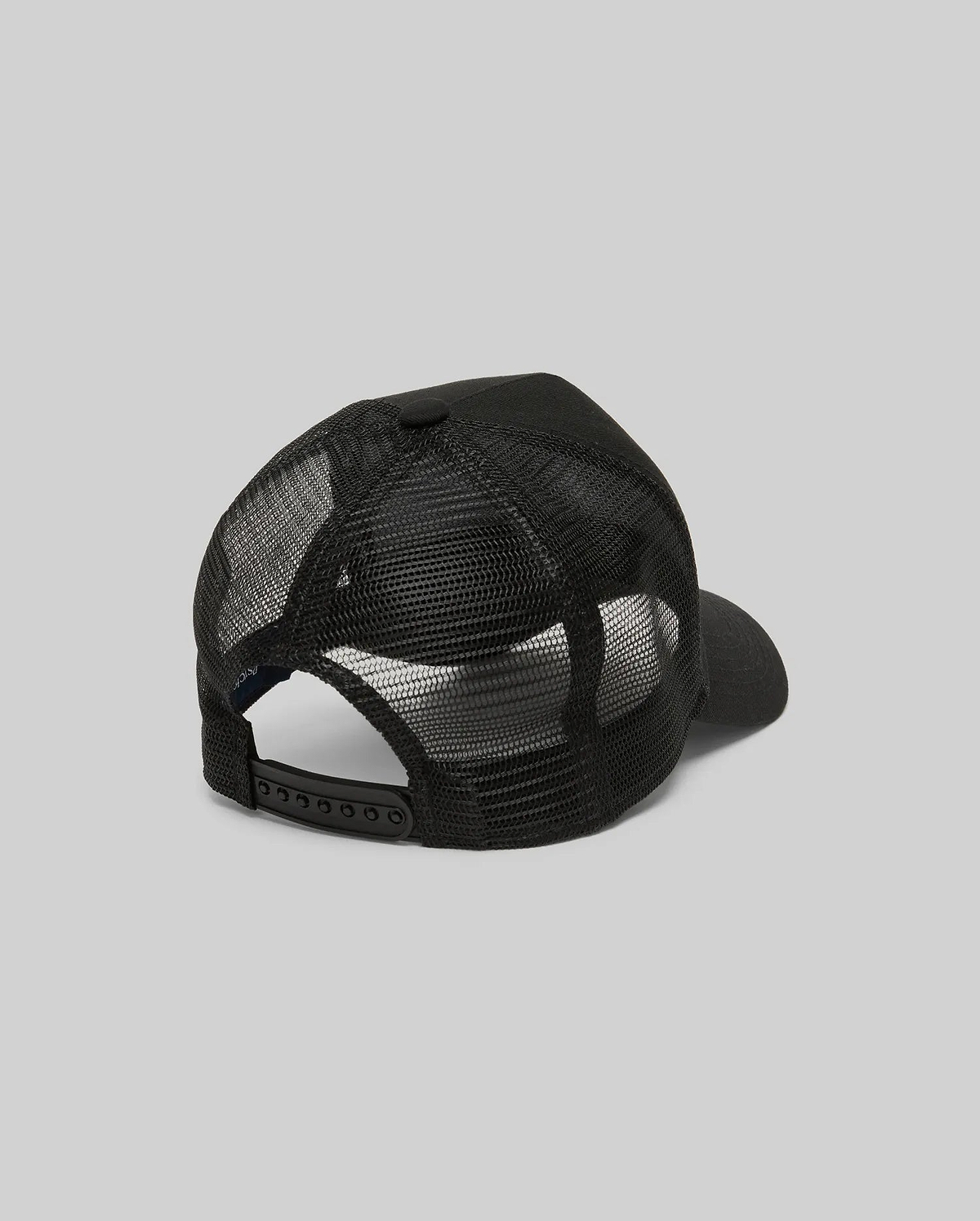 The Psycho Bunny MENS RYDER TRUCKER CAP (MO1500030) in black mesh and cotton twill is shown from the back, featuring an adjustable snapback closure and curved brim against a plain gray background.