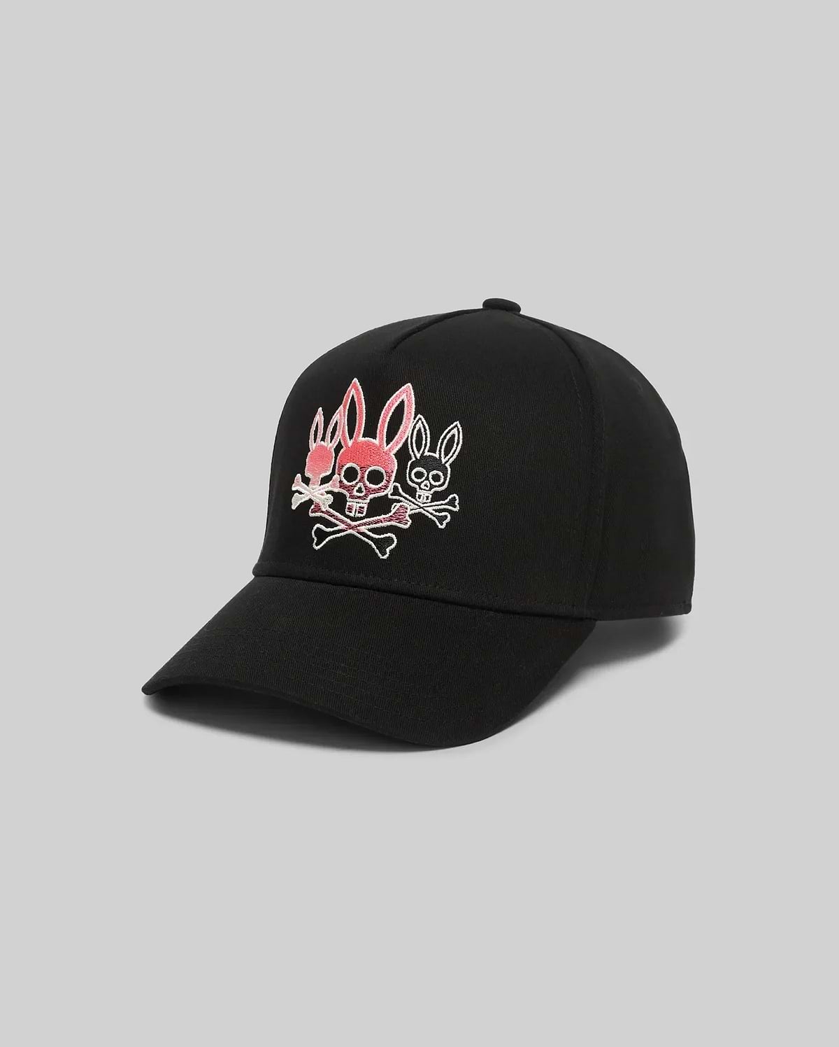 Mens Oscar Trucker Cap, black, with a bold embroidered Psycho Bunny logo on the front: a central pink bunny skull with crossbones, flanked by two smaller white outlined bunny skulls.