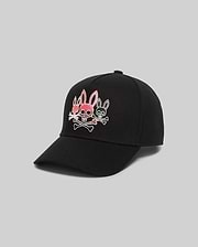 Mens Oscar Trucker Cap, black, with a bold embroidered Psycho Bunny logo on the front: a central pink bunny skull with crossbones, flanked by two smaller white outlined bunny skulls.