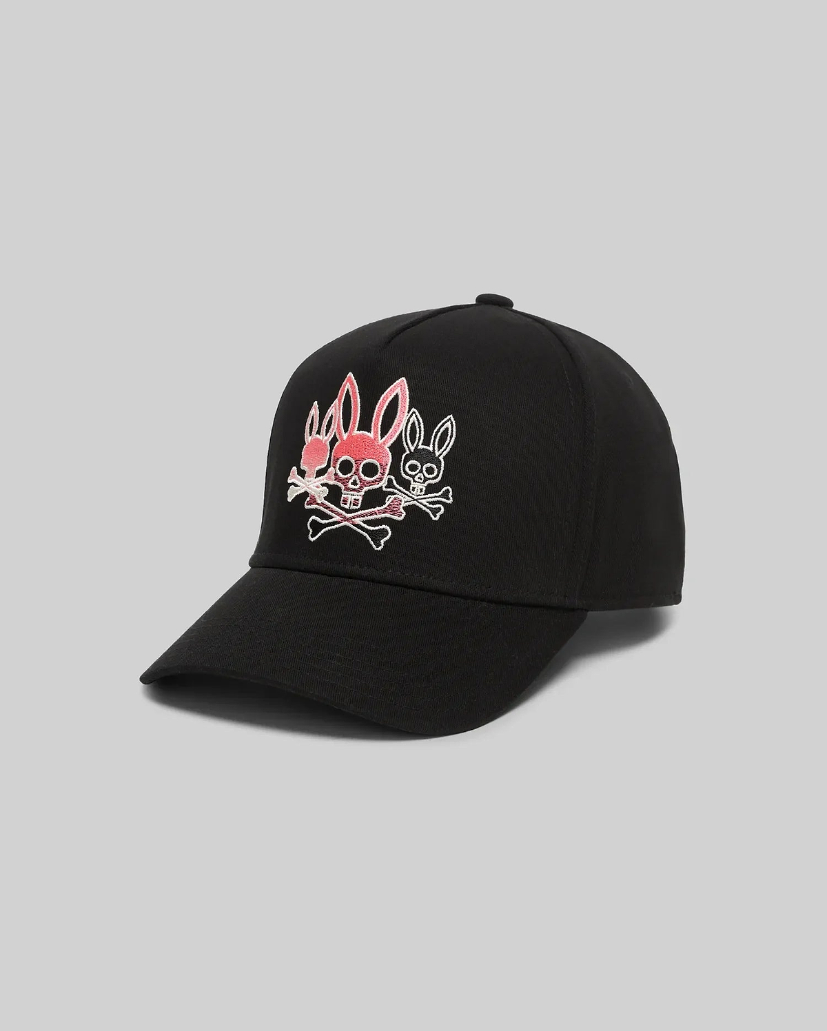 Mens Oscar Trucker Cap, black, with a bold embroidered Psycho Bunny logo on the front: a central pink bunny skull with crossbones, flanked by two smaller white outlined bunny skulls.