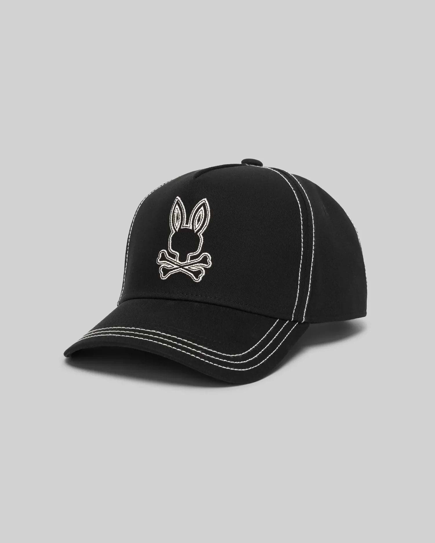 Mens Oscar Trucker Cap in black structured cotton twill, featuring a prominent white embroidered Psycho Bunny skull logo on the front and contrasting white stitching details throughout. (2)