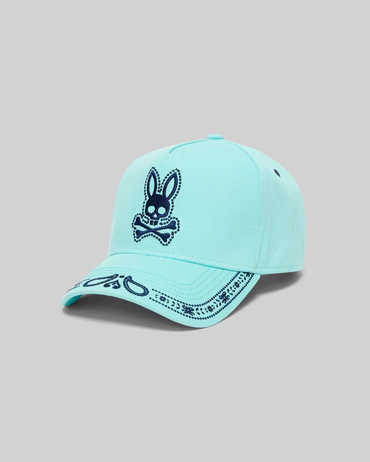 Mens Luke Trucker Cap in aqua with a large navy blue embroidered Psycho Bunny skull logo on the front and a detailed navy bandana pattern on the brim. (2)