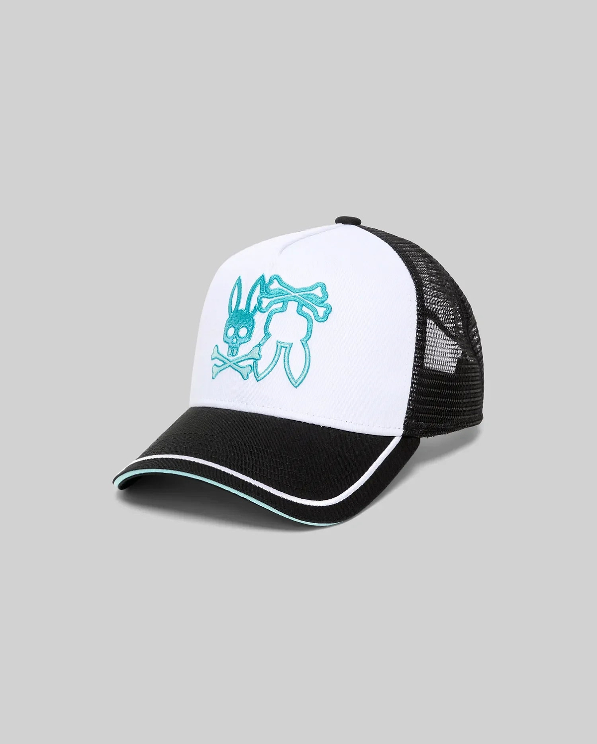 Mens Aram Trucker Cap with a white cotton twill front panel, black mesh back, and black brim featuring white and teal piping. A large, central teal embroidered Psycho Bunny skull logo with crossbones adorns the front.
