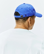 Vibrant royal blue Mens Jimmy Baseball Cap, classic fit cotton twill with an adjustable strap and a small engraved Psycho Bunny skull logo on the gunmetal buckle at the back.