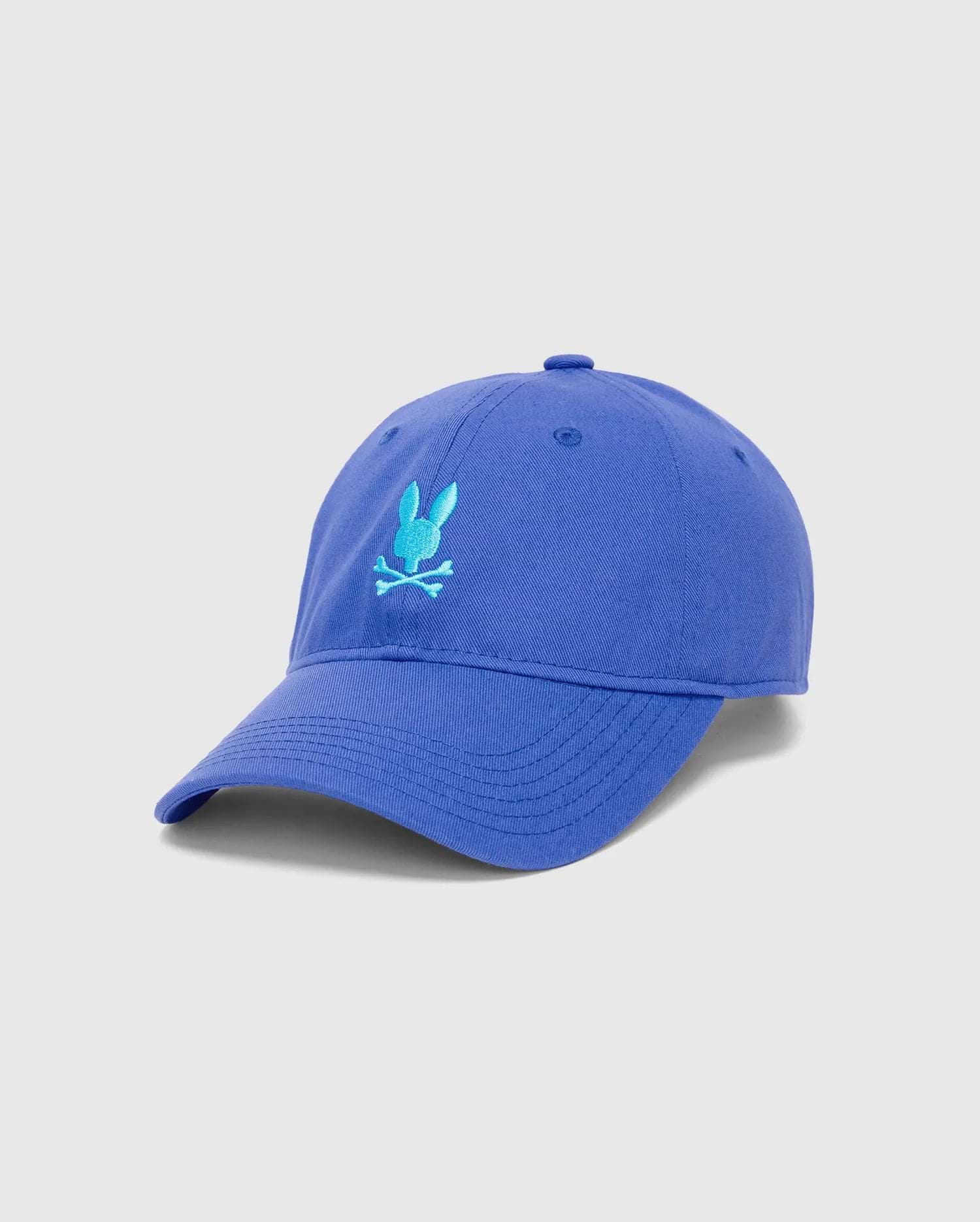 Mens Jimmy Baseball Cap in royal blue cotton twill, featuring a prominent light blue embroidered Psycho Bunny skull logo on the front, with a classic curved brim.