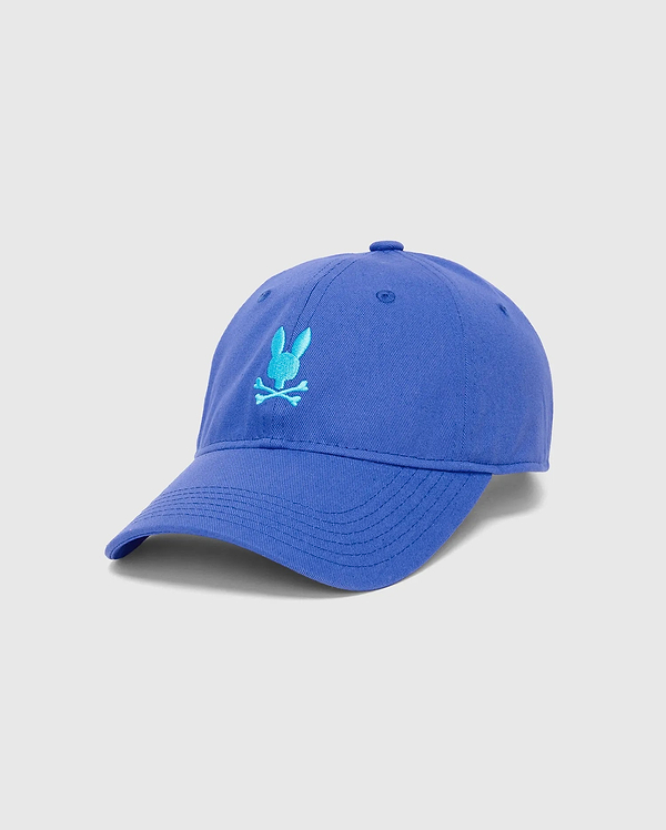 Mens Jimmy Baseball Cap in royal blue cotton twill, featuring a prominent light blue embroidered Psycho Bunny skull logo on the front, with a classic curved brim.