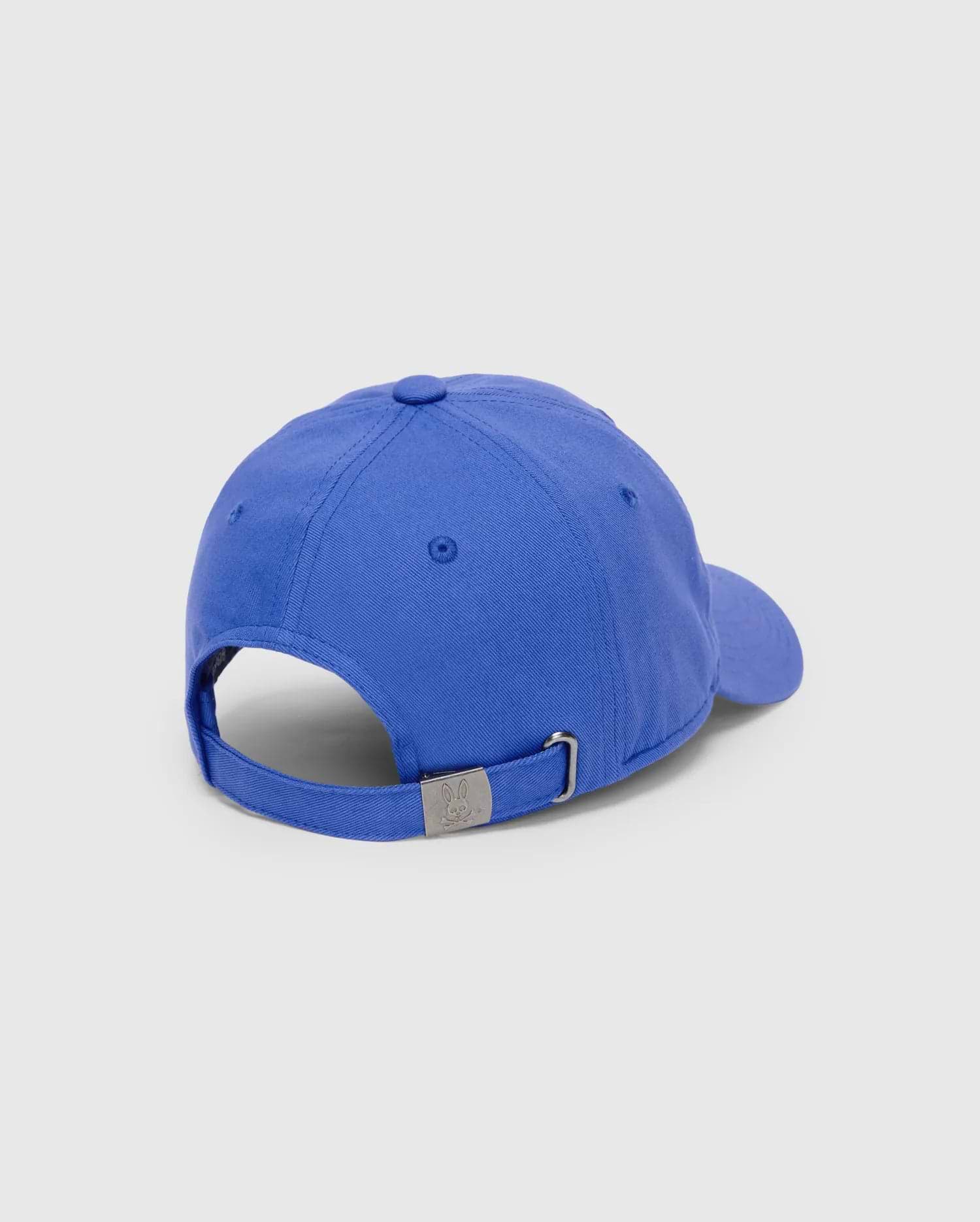 Mens Jimmy Baseball Cap, vibrant royal blue cotton twill with an adjustable strap and a gunmetal buckle featuring a small embossed Psycho Bunny skull logo at the back.