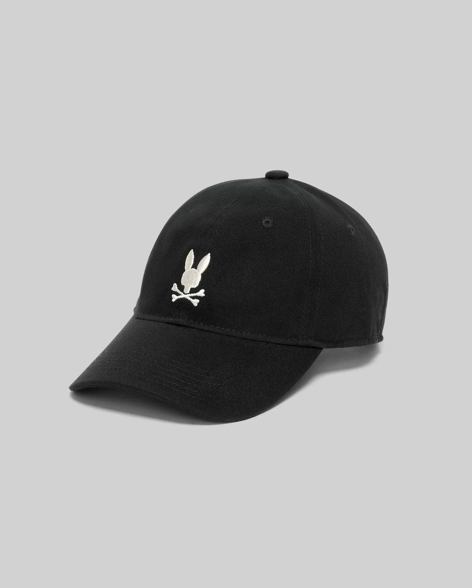 Mens Jimmy Baseball Cap, a classic black cotton twill cap with a prominent white embroidered Psycho Bunny skull and crossbones logo centered on the front panel.