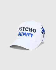 White Mens Brad Trucker Cap featuring large embroidered PSYCHO in dark blue and BUNNY in bright blue on the front, with an embroidered blue palm tree on the side.