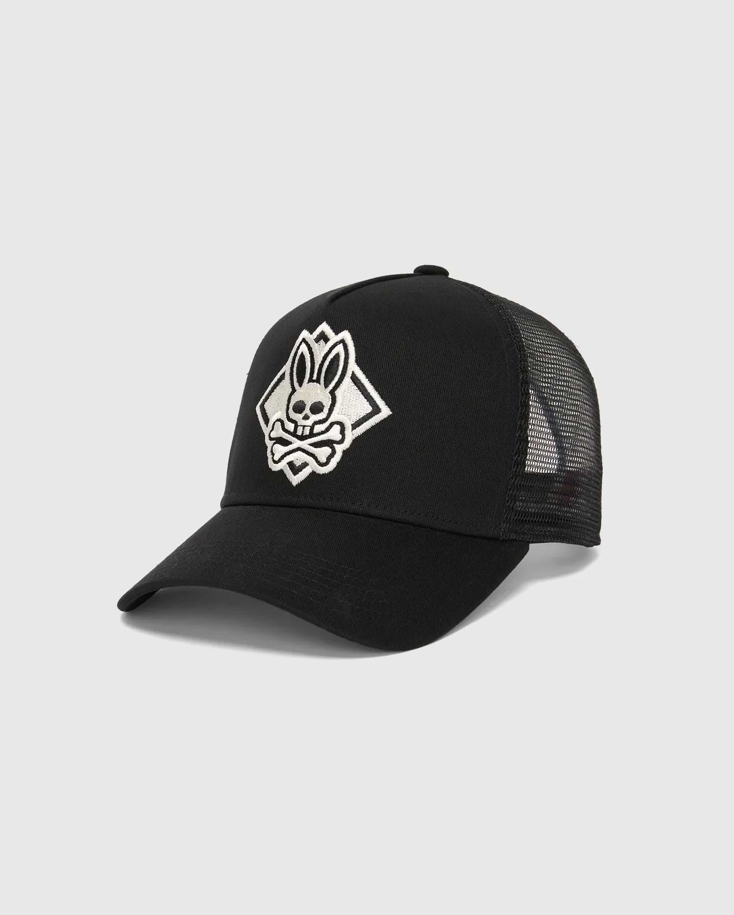 Mens Tobias Trucker Cap, black with a large, white embroidered Psycho Bunny skull logo in a diamond outline on the front, featuring breathable mesh back panels and a cotton twill front.