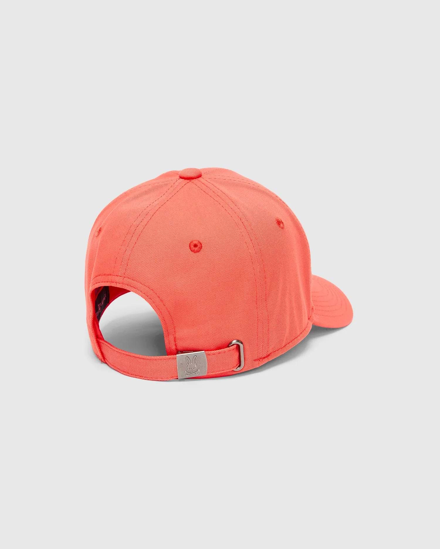 Mens Craig Baseball Cap in vibrant coral twill, featuring an adjustable strap with a silver-tone metal buckle engraved with the iconic Psycho Bunny skull logo.
