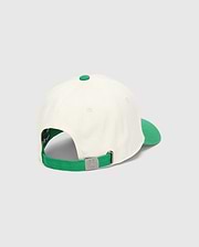 Mens Craig Baseball Cap in cream with a vibrant green brim, top button, and adjustable strap. The back features a silver metal buckle embossed with the iconic Psycho Bunny skull logo.