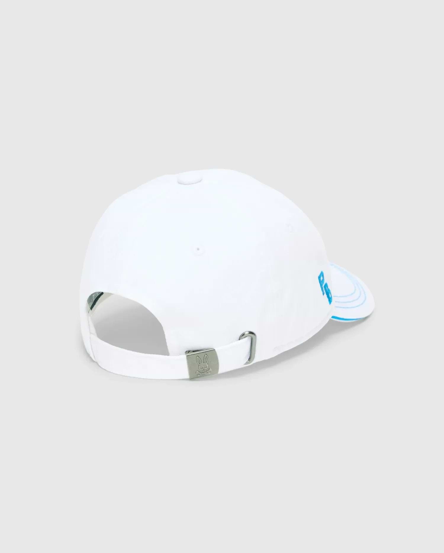 Mens Ray Baseball Cap, white smooth cotton twill with light blue embroidered PB initials on the side panel, concentric lines on the brim, and a metal buckle featuring the Psycho Bunny skull logo.