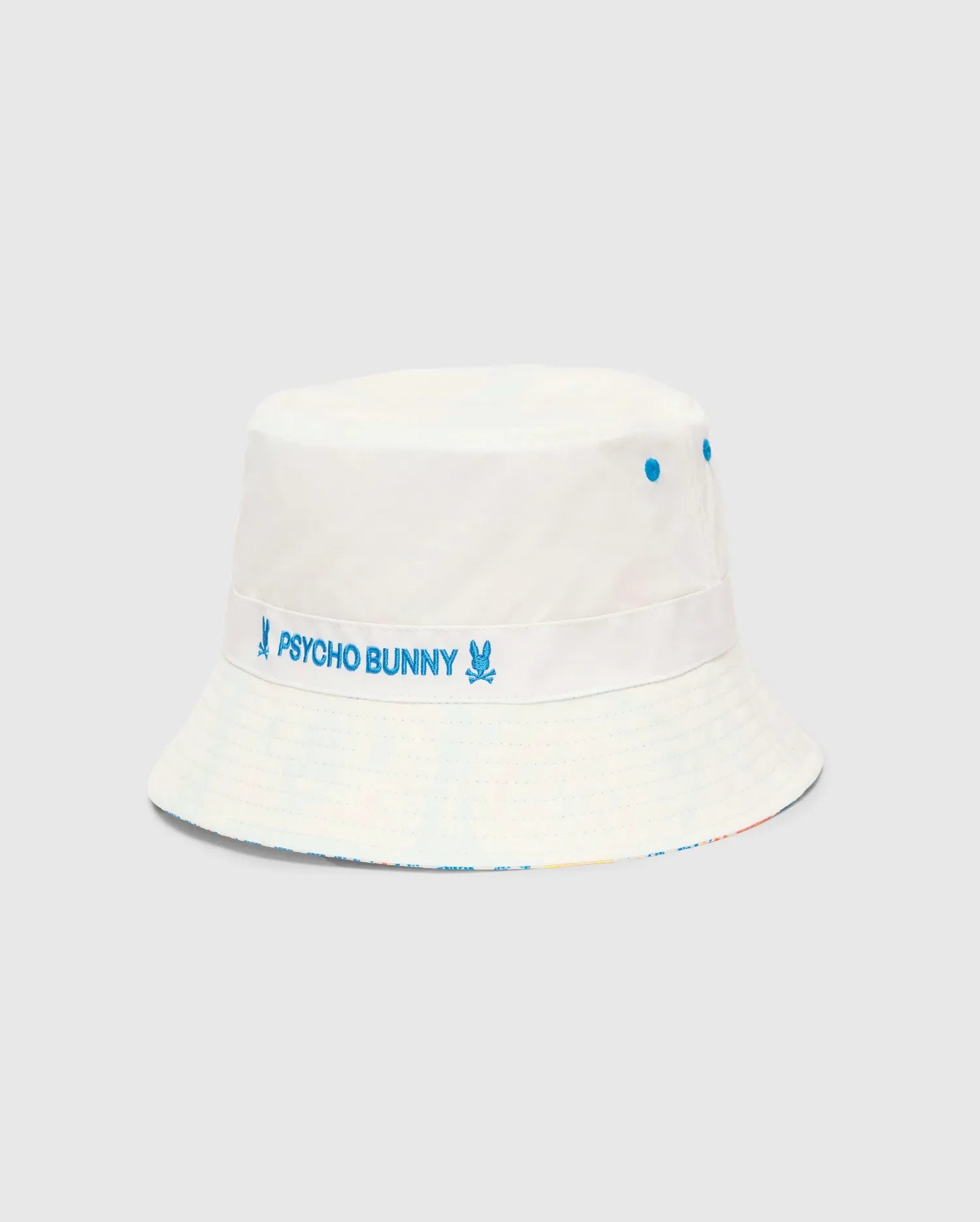 Mens Frank Reversible Bucket Hat, white with blue embroidered Psycho Bunny text and skull logos on a band, blue eyelets, and a subtle multicolor reversible brim.
