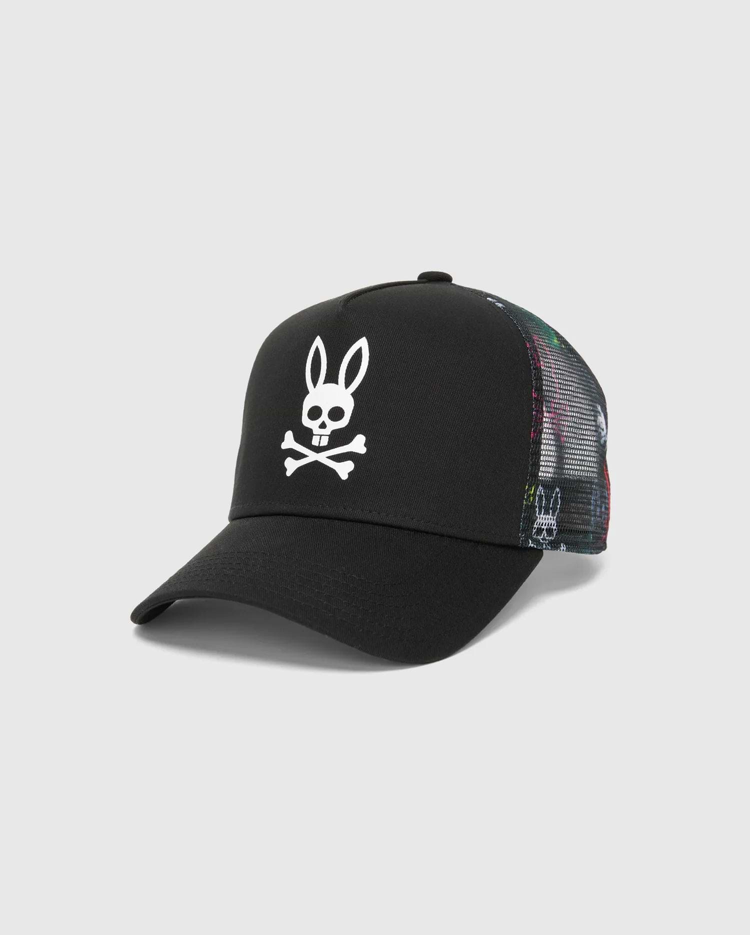 Mens Quintin Trucker Cap featuring a black twill front panel, multicolor patterned mesh back, and a prominent white embroidered Psycho Bunny skull logo.