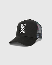 Mens Quintin Trucker Cap featuring a black twill front panel, multicolor patterned mesh back, and a prominent white embroidered Psycho Bunny skull logo.