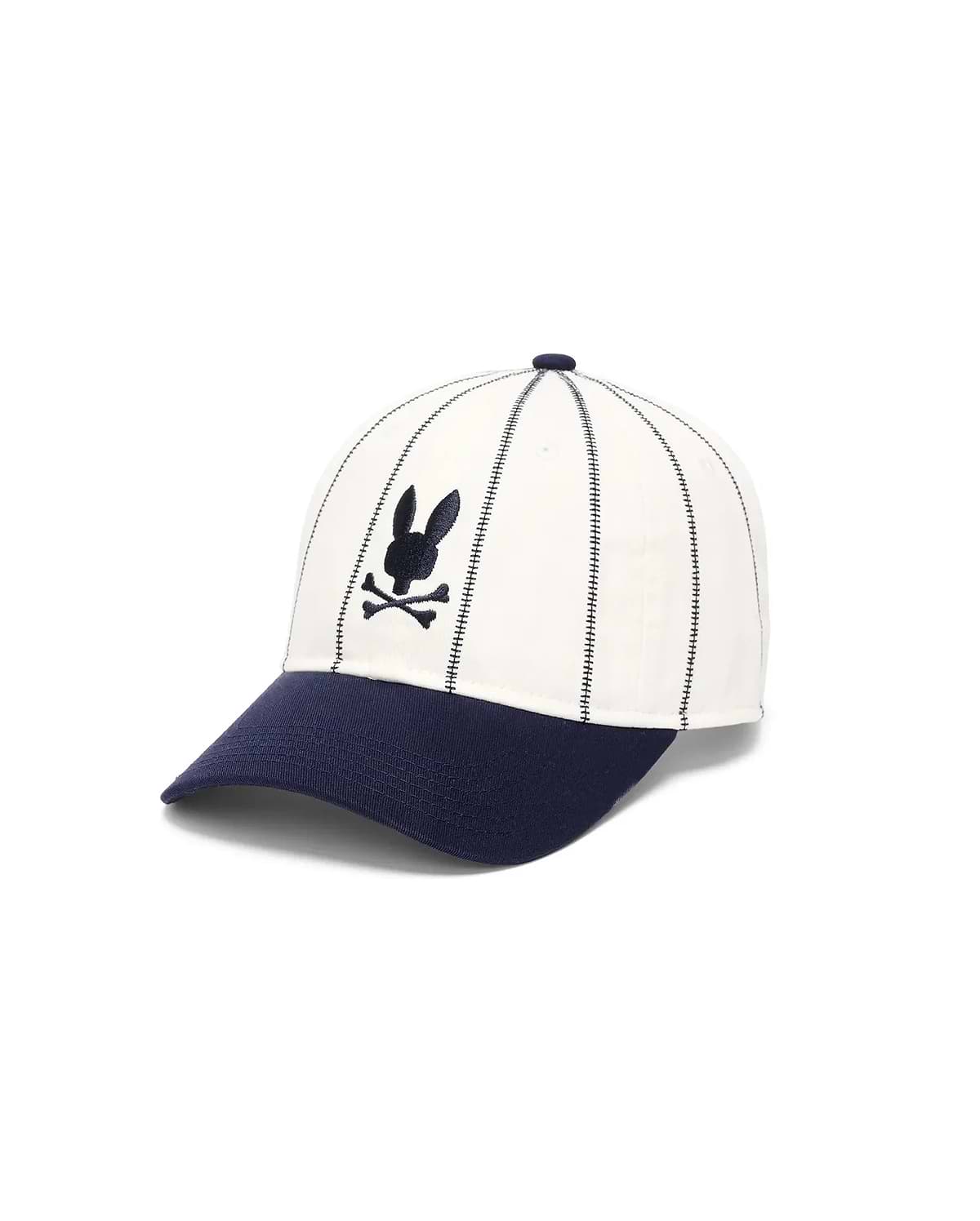 Mens Nathaniel Soft Baseball Cap featuring a cream crown with vertical navy dash stitching, a navy brim, and a front-center embroidered navy Psycho Bunny skull logo.