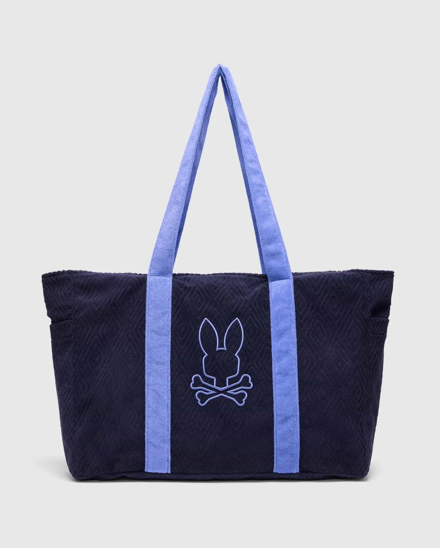 Navy Tristan Towel Tote with a subtle quilted diamond pattern, featuring periwinkle blue terry cloth straps and a large embroidered periwinkle Psycho Bunny skull logo on the front.