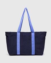 Tristan Towel Tote, a premium navy blue bag featuring a distinctive quilted diamond pattern throughout its plush towel-textured body, complemented by bold periwinkle blue towel-textured shoulder straps.