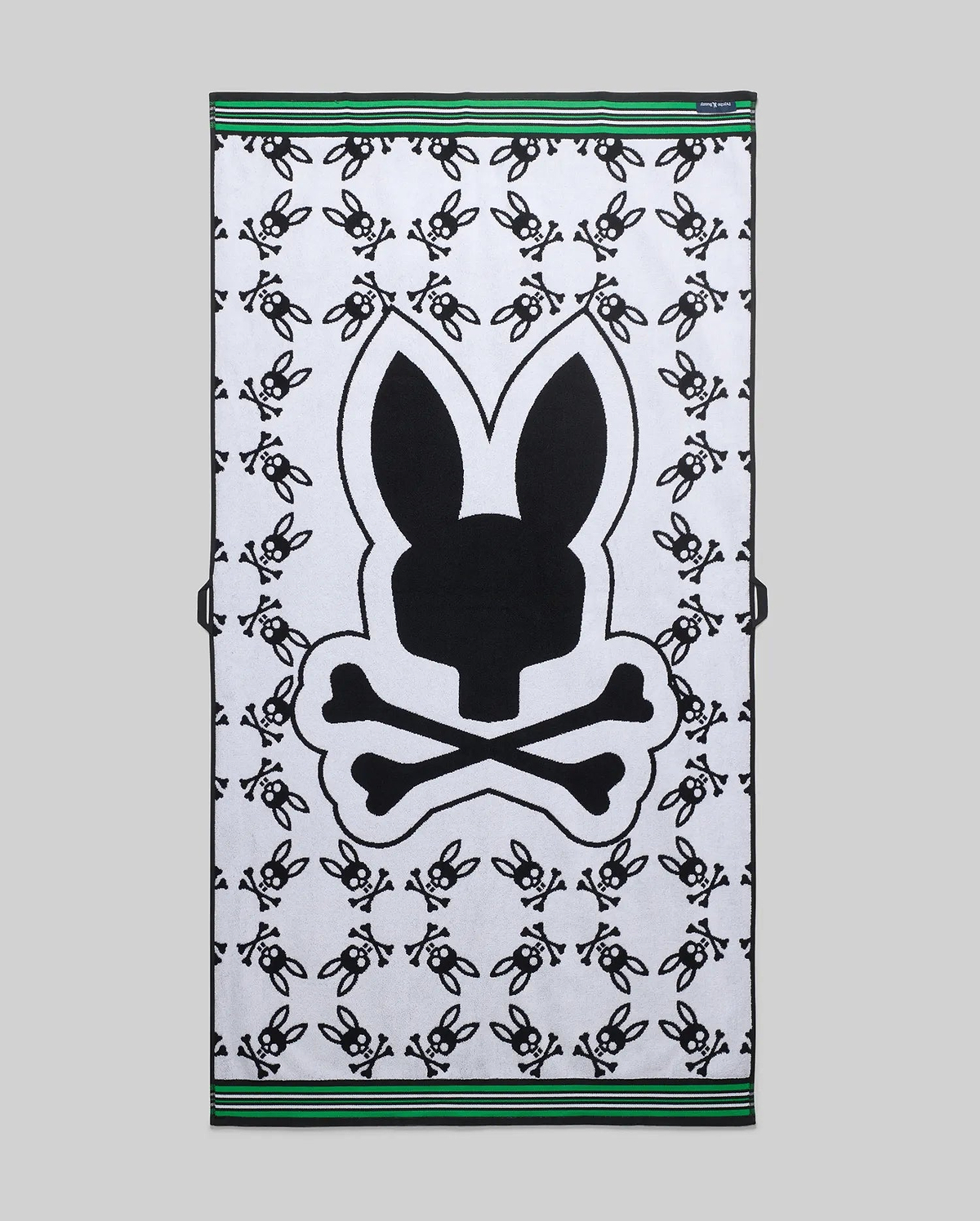 Mens All Over Bunny Towel in white terry cloth, featuring a large central black bunny skull logo, an all-over small black bunny skull pattern, and green and black striped borders. (2)