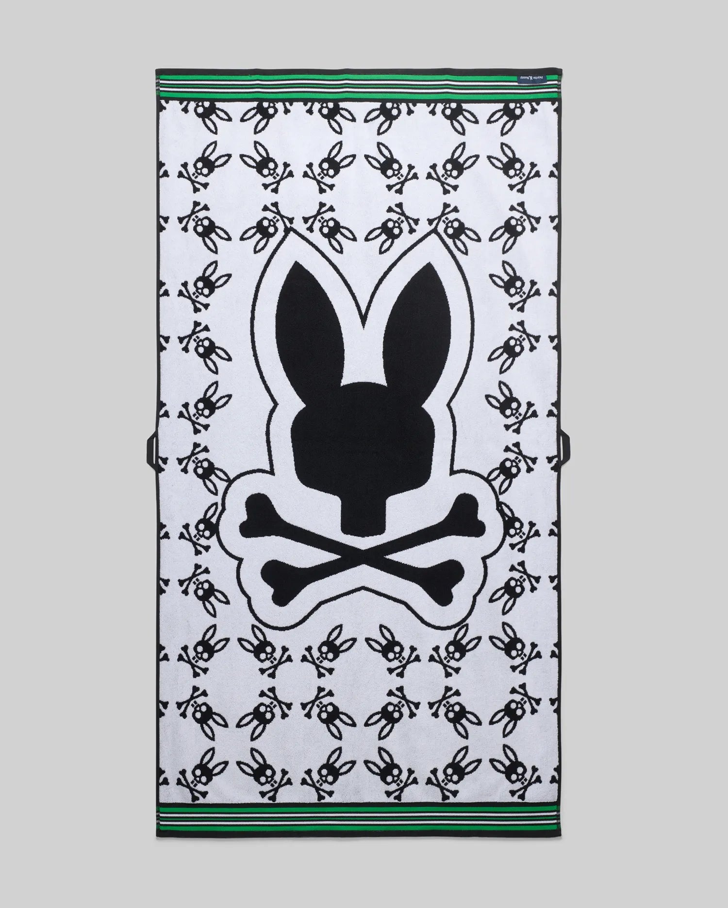 Mens All Over Bunny Towel in white terry cloth, featuring a large central black bunny skull logo, an all-over small black bunny skull pattern, and green and black striped borders. (2)