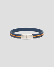 Mens Link Rubber Bracelet in navy blue rubber with an embedded orange chain detail, featuring a silver-toned metal clasp engraved with the Psycho Bunny skull logo and text. (1)
