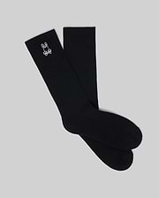 Premium black Mens New Classic Sport Sock, featuring a ribbed knit texture and an iconic small white embroidered Psycho Bunny skull and crossbones logo on the outer crew cuff.