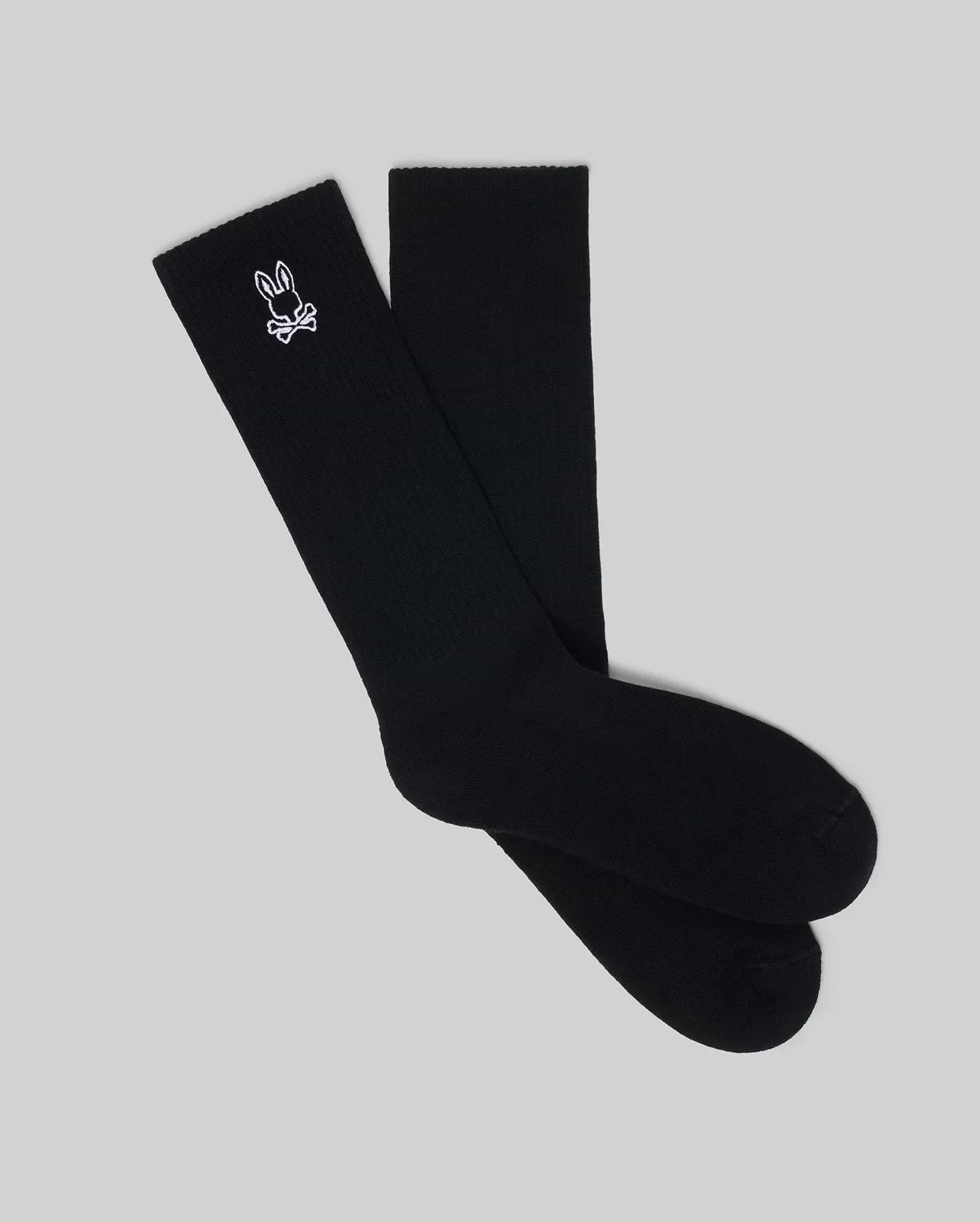 Premium black Mens New Classic Sport Sock, featuring a ribbed knit texture and an iconic small white embroidered Psycho Bunny skull and crossbones logo on the outer crew cuff.