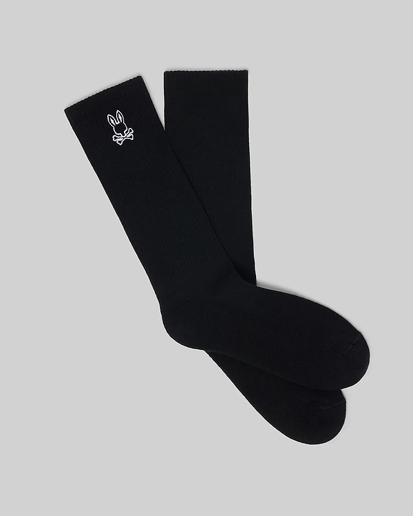 Premium black Mens New Classic Sport Sock, featuring a ribbed knit texture and an iconic small white embroidered Psycho Bunny skull and crossbones logo on the outer crew cuff.