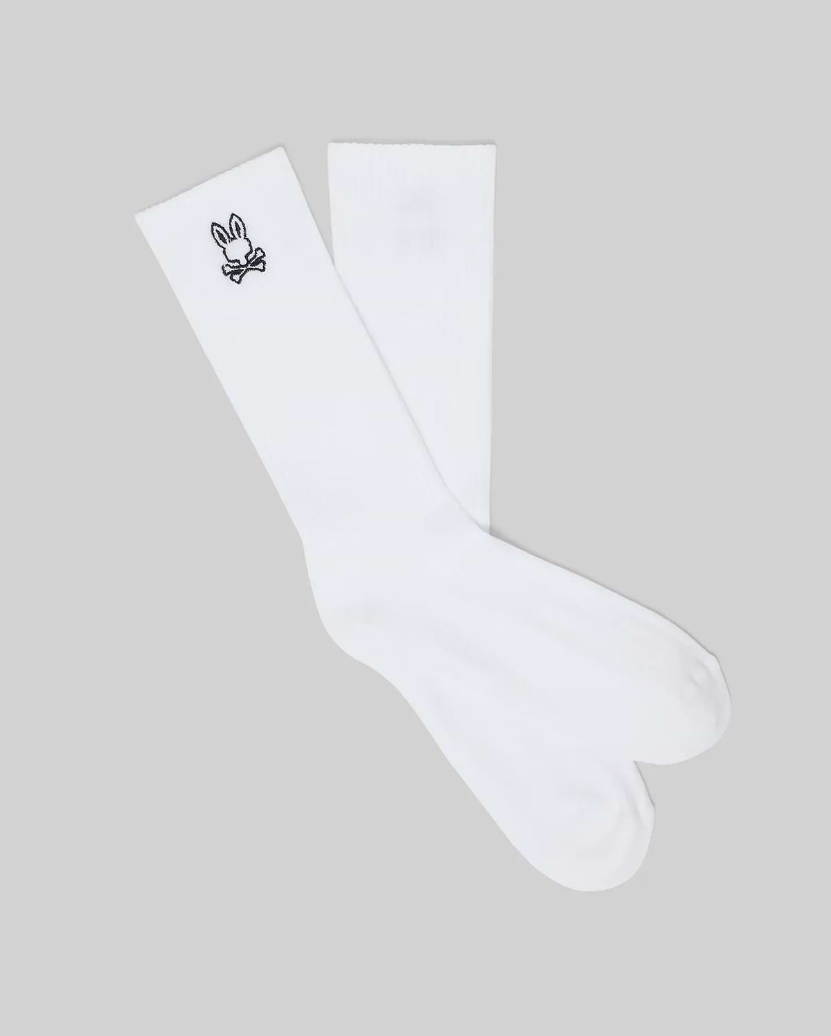 Mens New Classic Sport Sock, crisp white athletic crew socks featuring a ribbed cuff and a small, iconic black embroidered Psycho Bunny skull logo on the outer ankle.