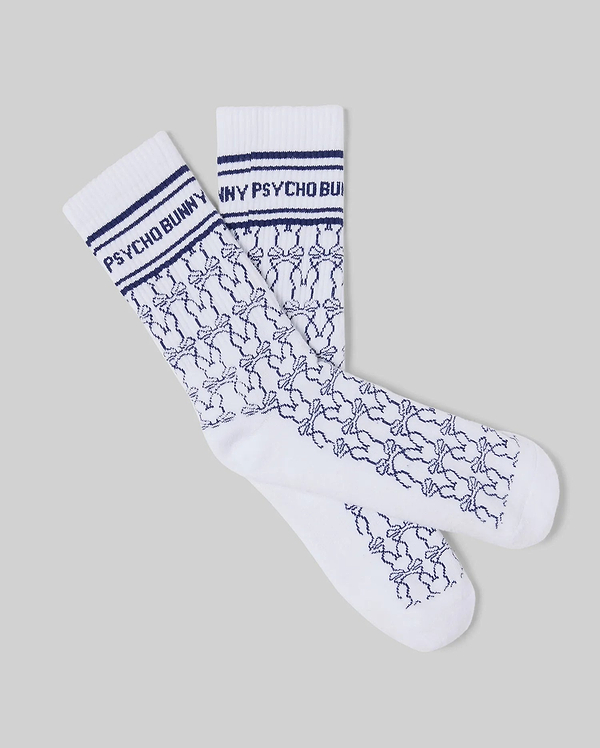 Mens Kace Bunny Pattern Sport Sock, white knit with navy blue ribbed cuffs, featuring Psycho Bunny text and stripes, plus an all-over small navy bunny skull pattern.