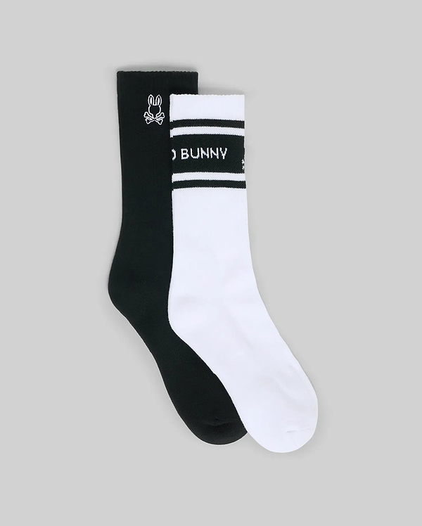 The Psycho Bunny MENS 2 PACK SPORT SOCK (MO2200037) features one black sock with a white bunny logo and one white sock with black stripes, "BUNNY" text, and a bunny logo, shown on a plain grey background.