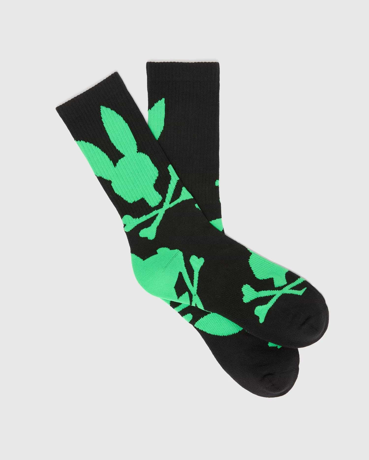 Mens Big Bunny Sport Sock, black knit with a bold, all-over neon green Psycho Bunny skull and crossbones logo pattern, featuring a comfortable crew length fit.
