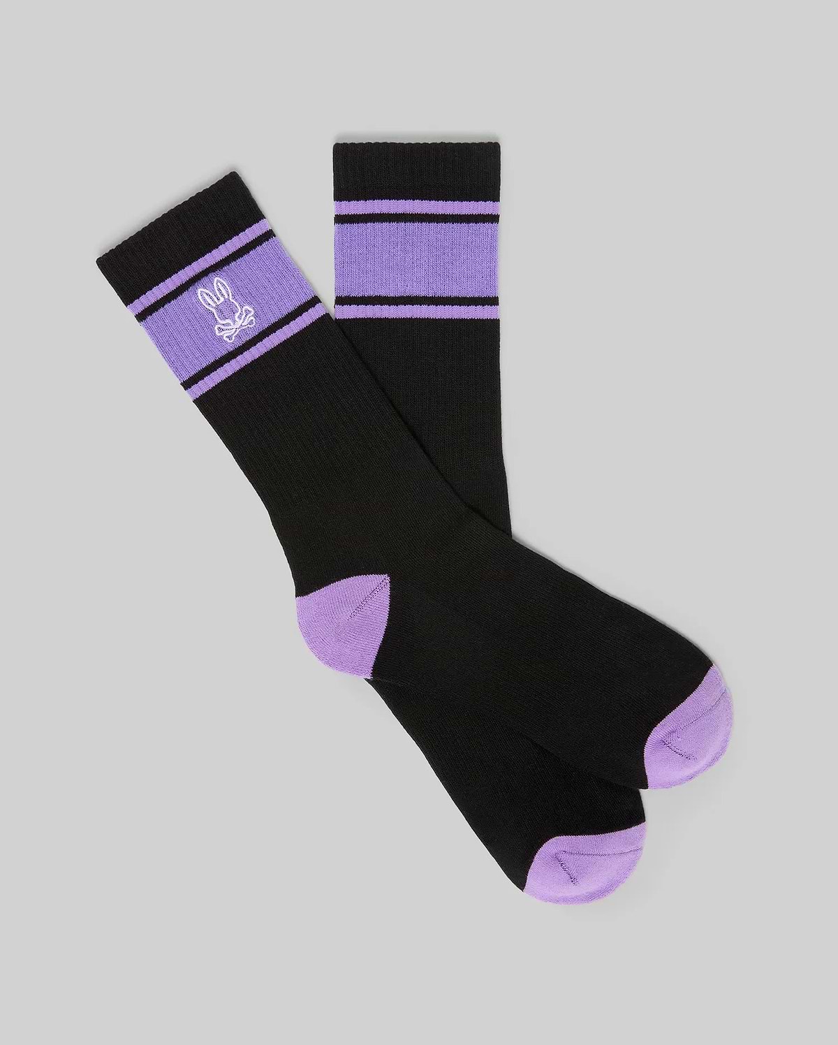 Mens Striped Sport Sock in black with purple accent stripes on the ribbed cuff, featuring an embroidered Psycho Bunny skull logo and purple contrast toe and heel.