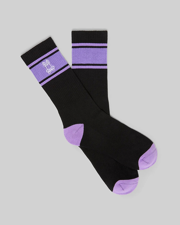 Mens Striped Sport Sock in black with purple accent stripes on the ribbed cuff, featuring an embroidered Psycho Bunny skull logo and purple contrast toe and heel.