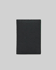 Black leather Passport Holder featuring an all-over embossed Psycho Bunny skull logo pattern, accented with a vibrant green interior edge, showcasing refined streetwear style. (2)
