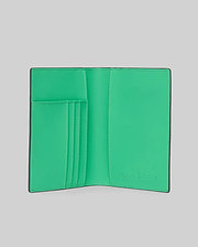 Passport Holder with a vibrant green interior and black exterior, featuring multiple card slots with white stitching and an embossed Psycho Bunny logo on the bottom right. (3)