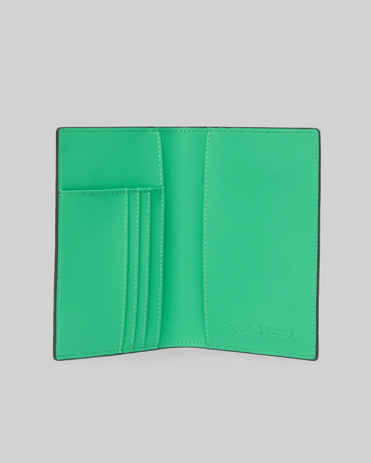 Passport Holder with a vibrant green interior and black exterior, featuring multiple card slots with white stitching and an embossed Psycho Bunny logo on the bottom right. (3)