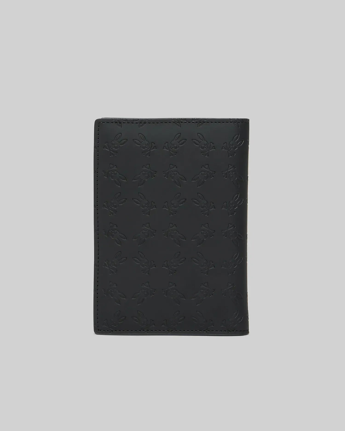 Black Passport Holder, a premium accessory featuring a subtle yet striking all-over embossed Psycho Bunny skull logo pattern on its smooth, durable leather-like surface. (4)