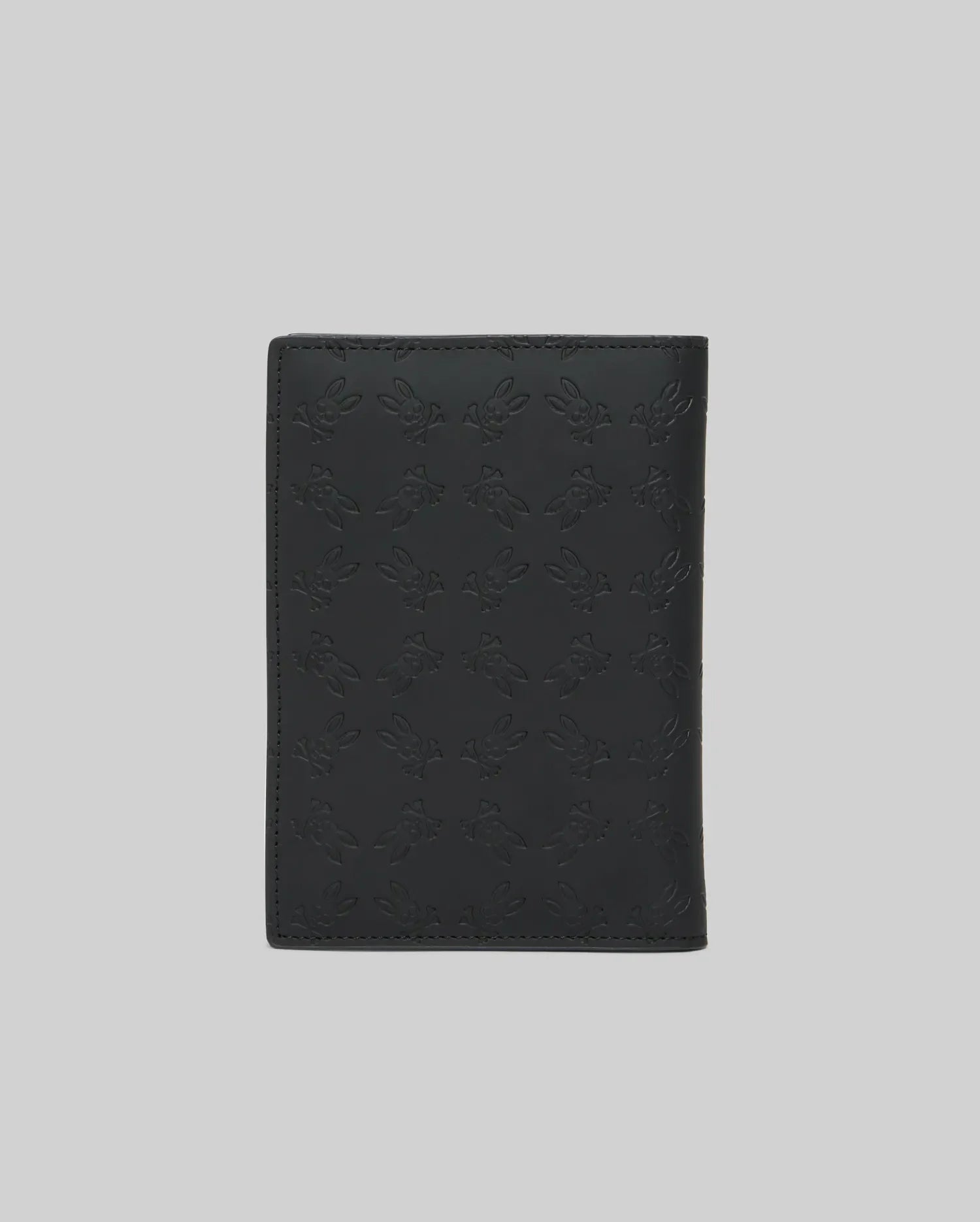 Black Passport Holder, a premium accessory featuring a subtle yet striking all-over embossed Psycho Bunny skull logo pattern on its smooth, durable leather-like surface. (4)