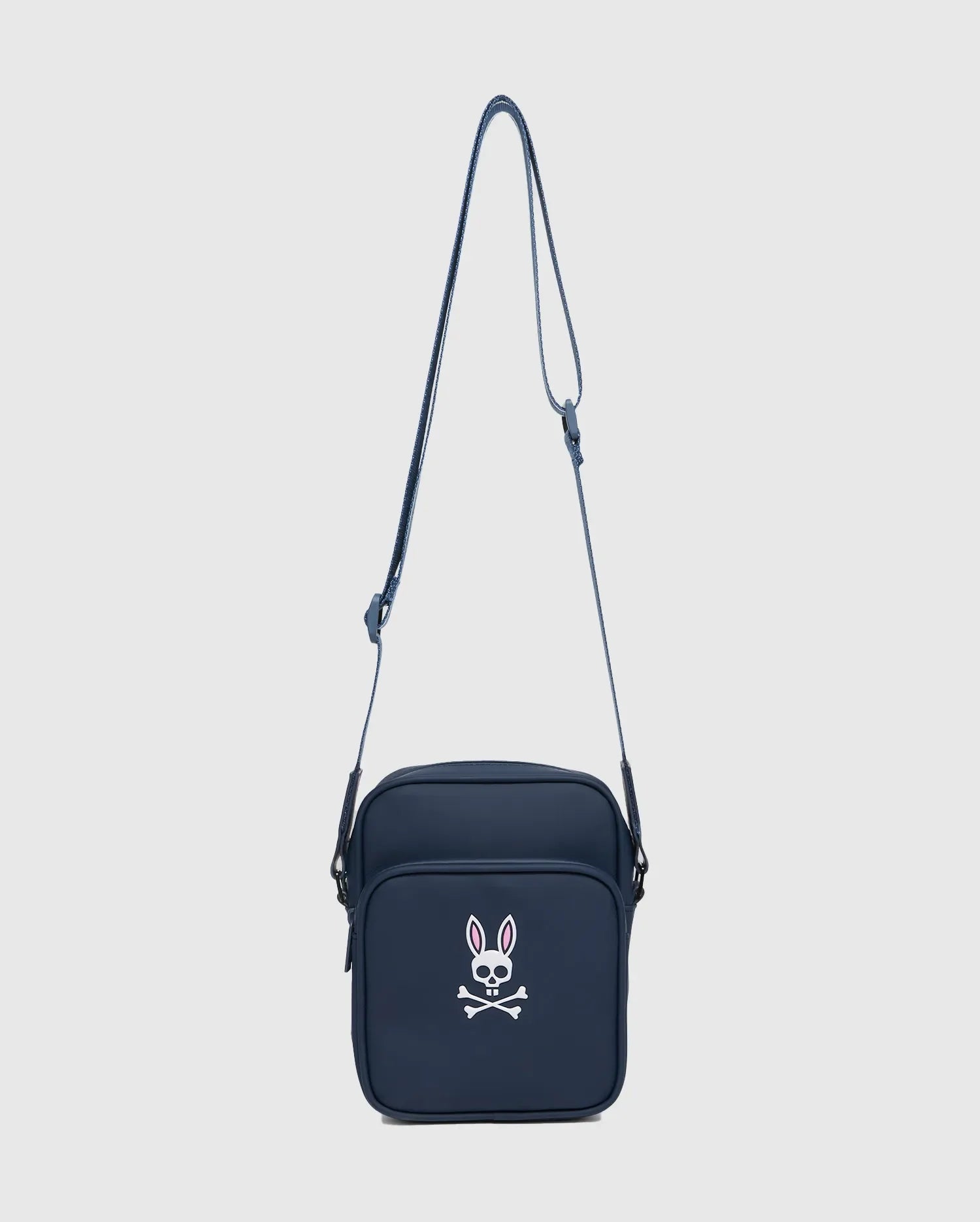 Classic Bunny Messenger Bag in navy blue, featuring a prominent white and pink Psycho Bunny skull logo on the front pocket, made from smooth, durable fabric.